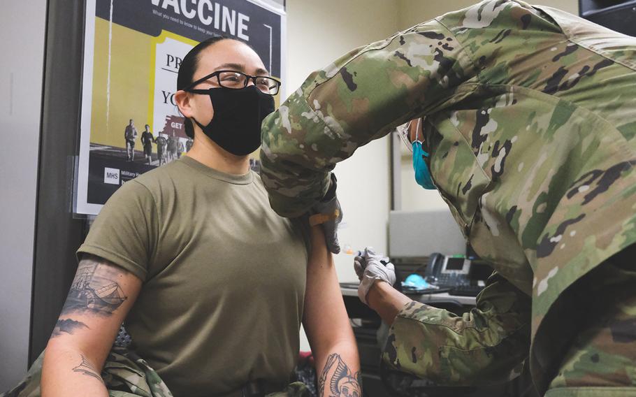 U.S. Army Health Center Vicenza Pharmacy Technician Spc. Siary Williams administers the COVID-19 vaccine to Pfc. Brooke Sandoval, a combat medic, Jan. 8, 2021 in Vicenza, Italy.