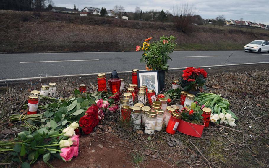 A roadside memorial of flowers and candles was created for a German teenager killed after a car crash with Tolman D. Roman Bahena, a Ramstein Air Base airman, near Weilerbach, Germany, in February 2019. Two local lawmakers say Germany should have more jurisdiction over criminal cases involving U.S. troops.