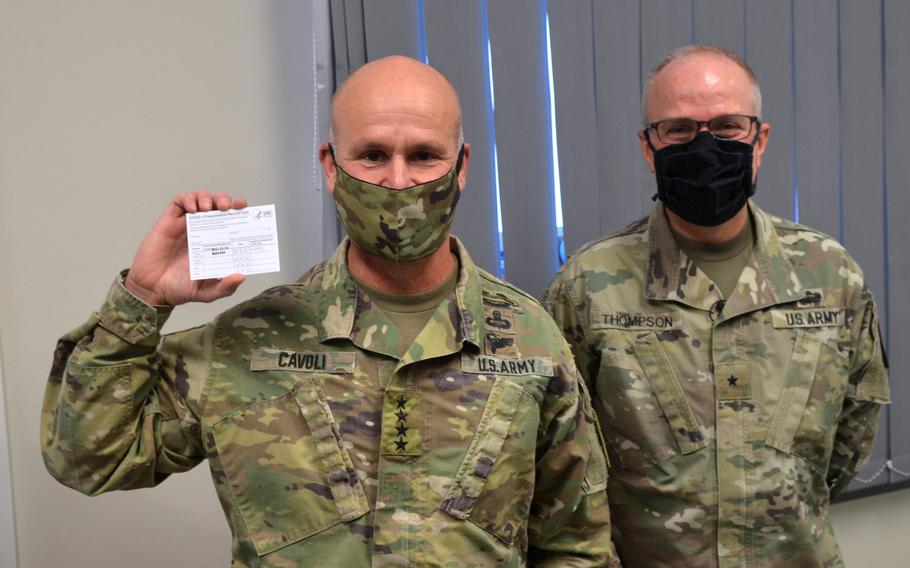 Gen. Christopher G. Cavoli, commander of U.S. Army Europe and Africa, holds up a COVID-19 vaccination card while standing next to Brig. Gen. Mark Thompson, commanding general of Regional Health Command Europe, at the Wiesbaden Army Health Clinic, Germany, Jan. 14, 2021.

