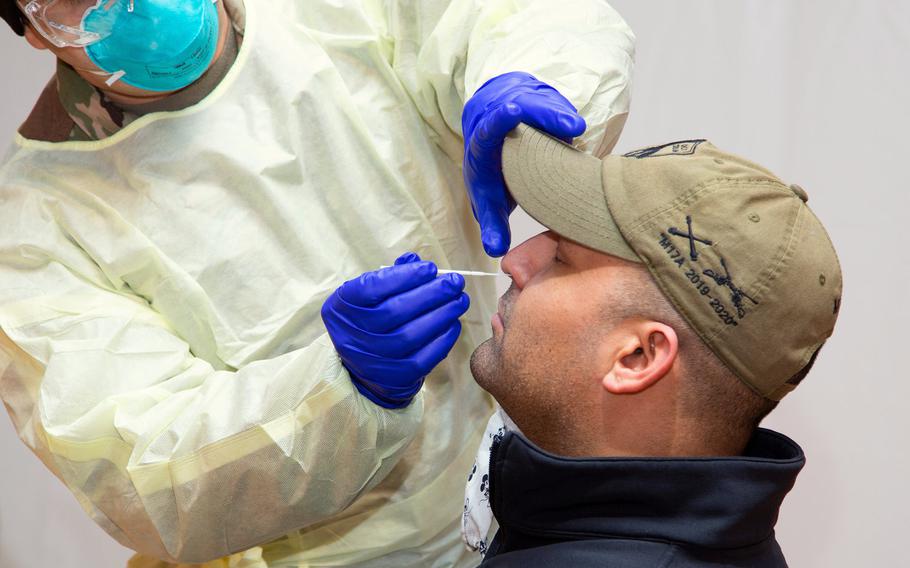An Army medic administers a coronavirus test in Hohenfels, Germany, Jan. 6, 2021. Air travelers to the U.S. are required to show proof of a negative COVID-19 test within 72 hours of travel before boarding a commercial airliner.

