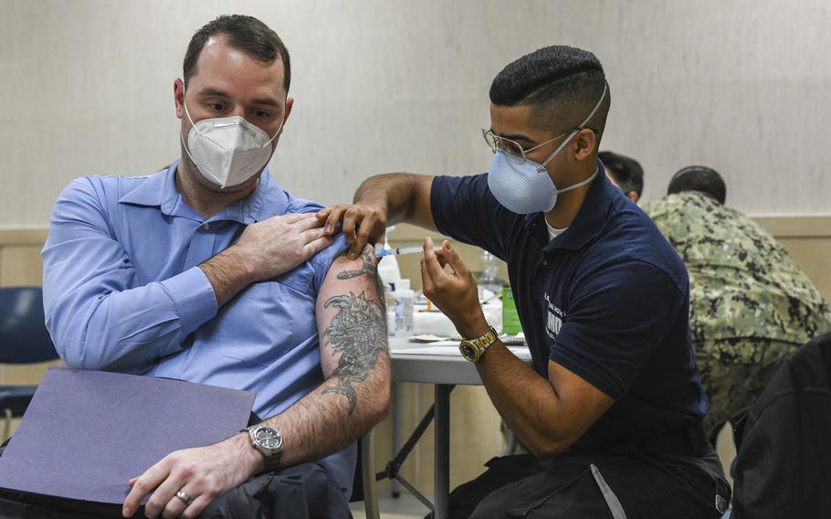 Joseph Rottier, a Defense Department civilian, receives a COVID-19 vaccination from Seaman Victor Rosario at U.S. Naval Support Activity Naples, Italy, Jan. 12, 2021. The Navy base began offering vaccinations to the general U.S. base population Thursday, Jan. 27.