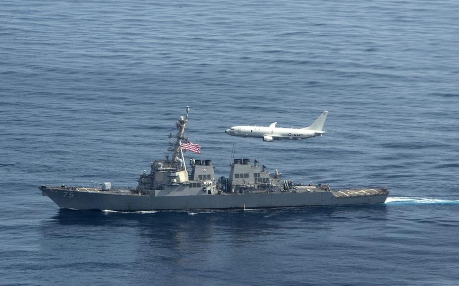 A U.S. Navy P-8 Poseidon flies over the destroyer USS Donald Cook in the Black Sea in January 2021. Ukraine is planning two new naval bases in the region, Prime Minister Denys Shmyhal said at NATO headquarters in Brussels, Feb. 9, 2021.

