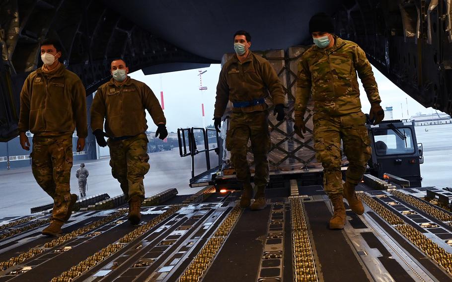 Airmen from the 721st Aerial Port Squadron walk into a C-17 Globemaster III aircraft to retrieve a pallet at Ramstein Air Base, Germany, Feb. 2, 2021. Although the U.S. military community makes up around 16% of the population of the Kaiserslautern district, Americans are not counted when German health officials calculate the key weekly infection rate for coronavirus.