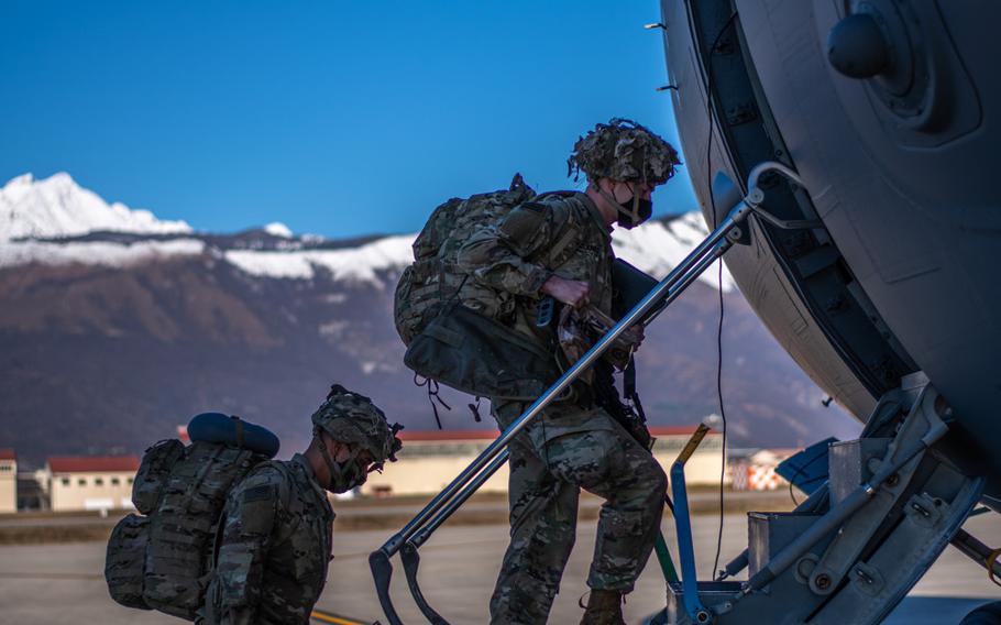 A paratrooper assigned to the 173rd Airborne Brigade boards a U.S. Air Force C-17 at Aviano Air Base, Italy, in preparation for movement to Camp Lemonnier, Djibouti, Dec. 14, 2020. 
