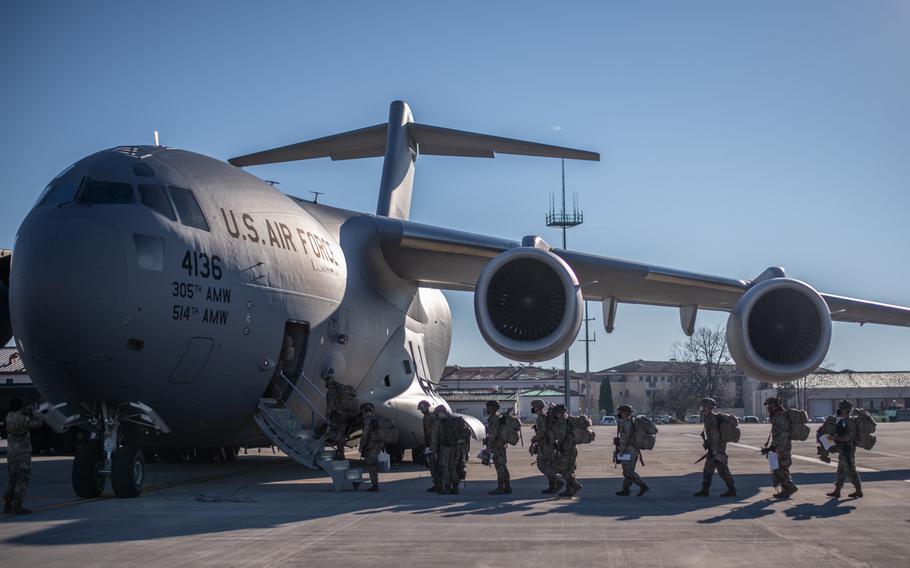 A paratrooper assigned to the 173rd Airborne Brigade boards a U.S. Air Force C-17 at Aviano Air Base, Italy in preparation for movement to Camp Lemonnier, Djibouti, Dec. 14, 2020.
