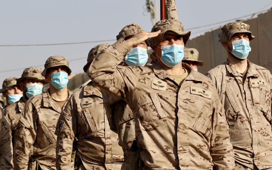 Spanish troops salute during a transfer of authority ceremony in Iraq in December 2020. NATO allies agreed Feb. 18, 2021 to a large expansion of NATO's training mission in Iraq. The additional allied troops could ease some of the demands on U.S. forces in the country.





