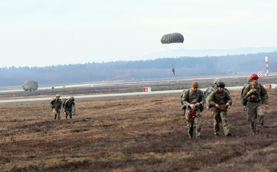 Paratroopers walk on the airfield at Ramstein Air Base, Germany, after completing a jump on Thursday, Feb. 18, 2021.
