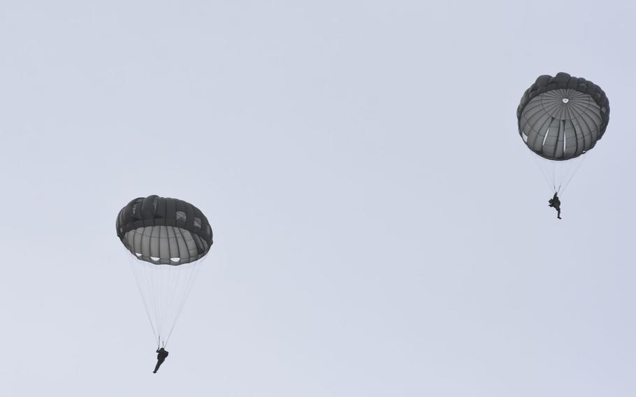 Paratroopers descend over a drop zone on Thursday, Feb. 18, 2021, inside the airfield at Ramstein Air Base, Germany. The Air Force made the jump happen on short notice, allowing the paratroopers with the 435th Contingency Response Group and other units in Germany to use the busy airfield to maintain their jump requirements.
