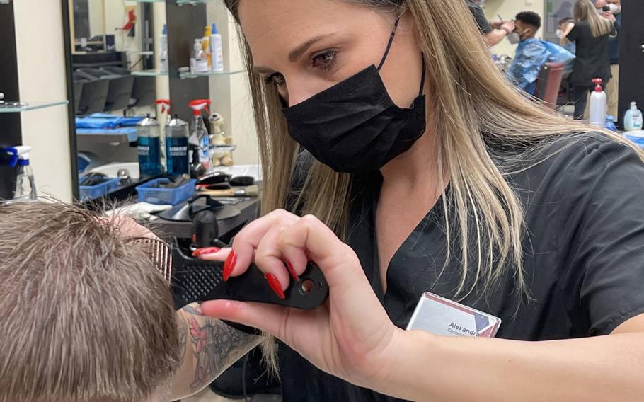 Alexandra, a barber at Tower Barracks, left, cuts 1st Lt. Ryan Twigg-Smith's hair in the barbershop at Tower Barracks in Grafenwoehr, Germany, Monday, March 1, 2021. Twigg-Smith says he used clippers to cut his hair himself during a 2½-month lockdown in Germany that began in mid-December.


