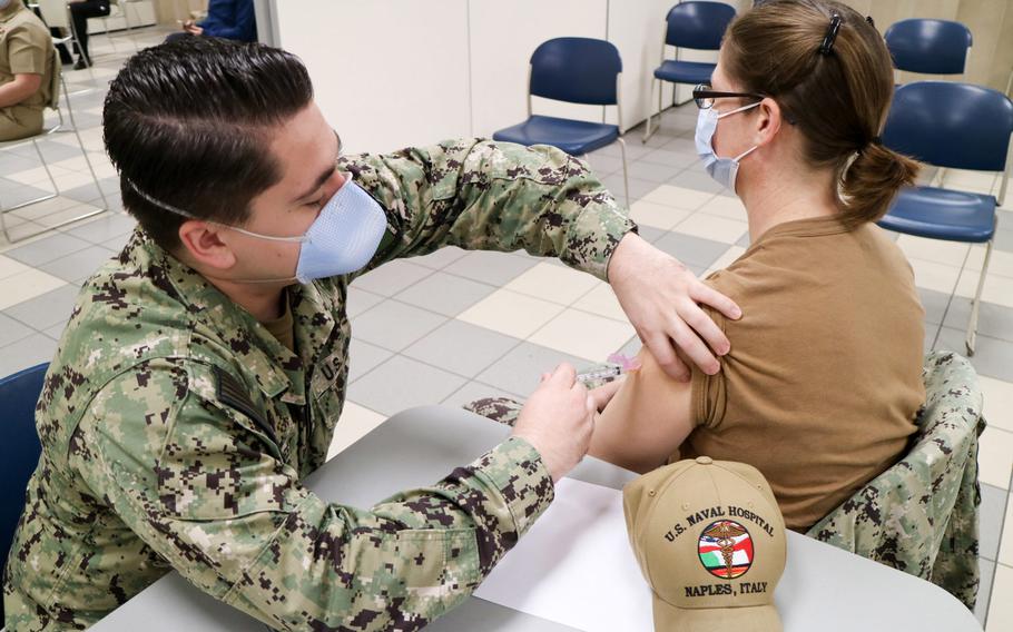 Petty Officer 3rd Class Dominic Laforest administers the second dose of the Moderna coronavirus vaccine to Lt. Stephanie Harris, the preventive medicine department head at U.S. Naval Hospital Naples, at Naval Support Activity Naples, Italy, Feb. 5, 2021. While some bases in Europe have a shortage of vaccine, Naples has for weeks been offering the vaccine to all eligible adult community members.