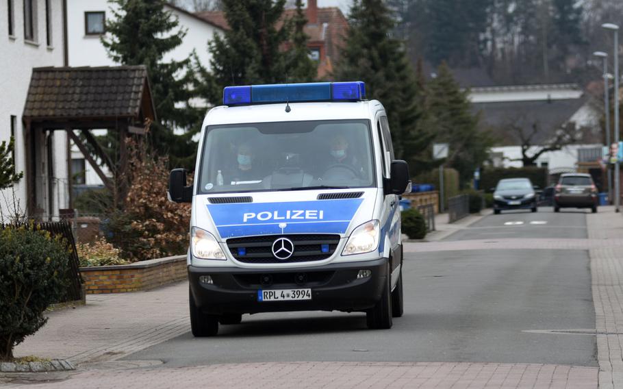 A German police van patrols a residential neighborhood in Weilerbach, Germany, after two people were found dead at a house in the town Tuesday, March 9, 2021.

