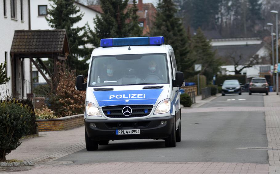 A German police van patrols a residential neighborhood in Weilerbach, Germany, after two people were found dead at a house in the town Tuesday, March 9, 2021.

