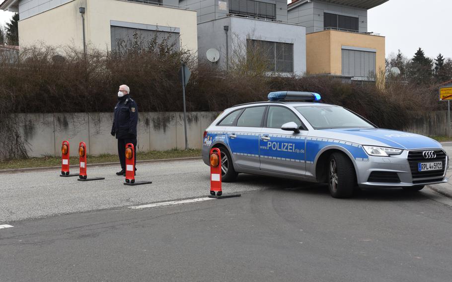 German police block the road to traffic leaving Weilerbach on the way to Hirschhorn, March 9, 2021. Two people were found dead at a house in the town Tuesday.

                                                           