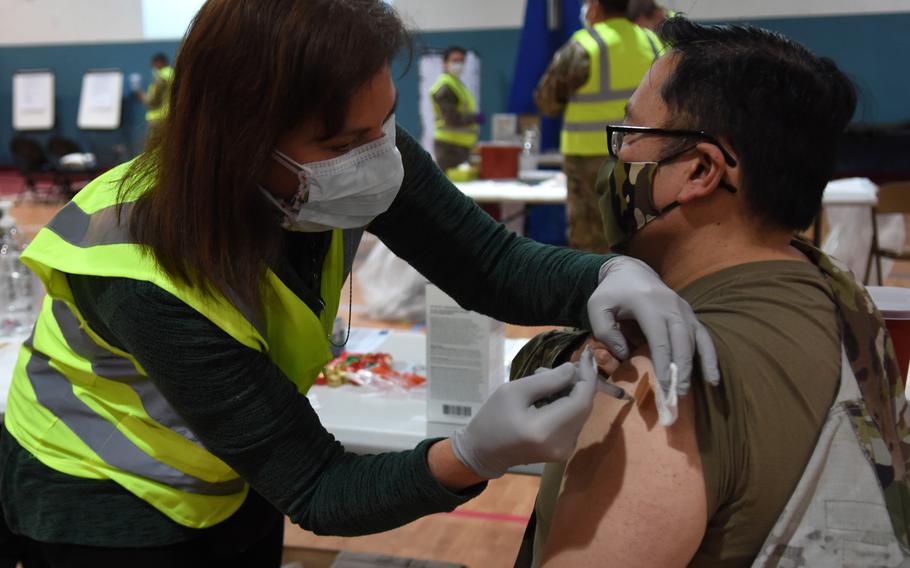 Sarah Lewis, a registered nurse with the 86th Medical Group, vaccinates group commander Col. Ryan Mihata against COVID-19 at Ramstein Air Base, Germany, in January 2021. Vaccination campaigns for the U.S. military and their families in Europe have slowed as supplies dwindle and new deliveries are delayed.