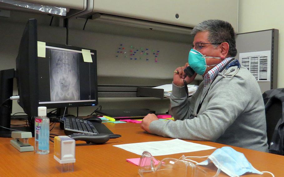 Dr. Rafael Nunez, a pediatrician at the U.S. Army Health Center in Vicenza, Italy, speaks on the phone March 9, 2021, with a parent about their child's diagnosis. Virtual appointments have been routine during the coronavirus pandemic.
                          