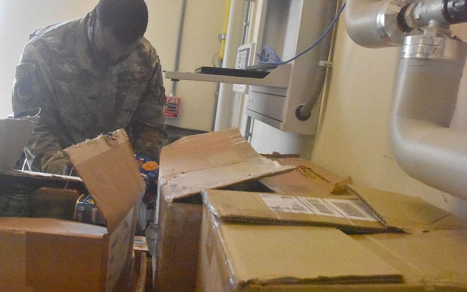 Staff Sgt. James Harris looks through almost two dozen boxes of nonperishable food items donated by those attached to Aviano Air Base, Italy. The 26-year-old Georgia native spearheaded the drive through the African American Heritage Committee on base and donated more than 1,100 items to the local branch of the Italian Red Cross.