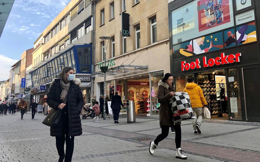 People walk through the pedestrian shopping district in Kaiserslautern, Germany, on March 23, 2021. Customers will require an appointment to shop in-person in Kaiserslautern county starting Tueday, March 31, 2021, after officials tightened coronavirus restrictions following a spike in new infections.

