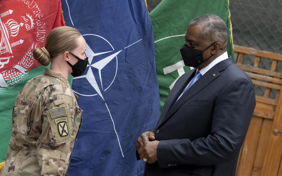 Defense Secretary Lloyd J. Austin III talks to a service member before giving her a coin in Kabul, Afghanistan, March 21, 2021. Austin will be traveling to Israel, Germany, Belgium and the United Kingdom beginning April 10, 2021.  

