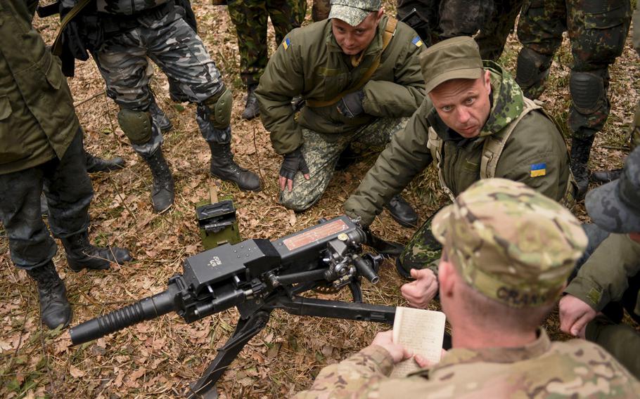 Ukrainian soldiers go over basic weapons procedures with a soldier from the 173rd Airborne Brigade in April 2015, during training in Yavoriv, Ukraine. A rapid Russian military buildup along the Ukrainian border in recent weeks has sparked fears of an invasion.
