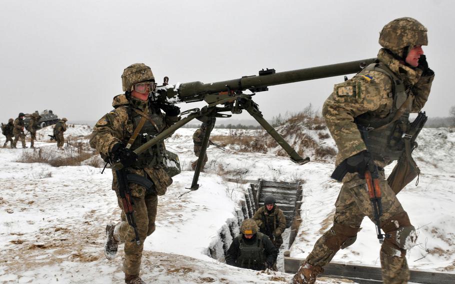 Ukrainian soldiers carry a recoilless rifle during a training exercise led by troops from the 2nd Infantry Brigade Combat Team, 3rd Infantry Division, in November 2016 at a range near Yavoriv, Ukraine. A rapid Russian military buildup along the Ukrainian border in recent weeks has sparked fears of an invasion.

