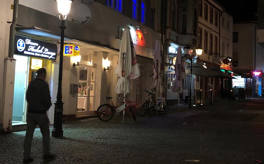 A person walks through the pedestrian zone in Kaiserslautern, Germany. The city, which is home to a large U.S. military community, will be under a 9 p.m. to 5 a.m. curfew starting Friday, April 16, 2021, following a sharp rise in new coronavirus infections.
