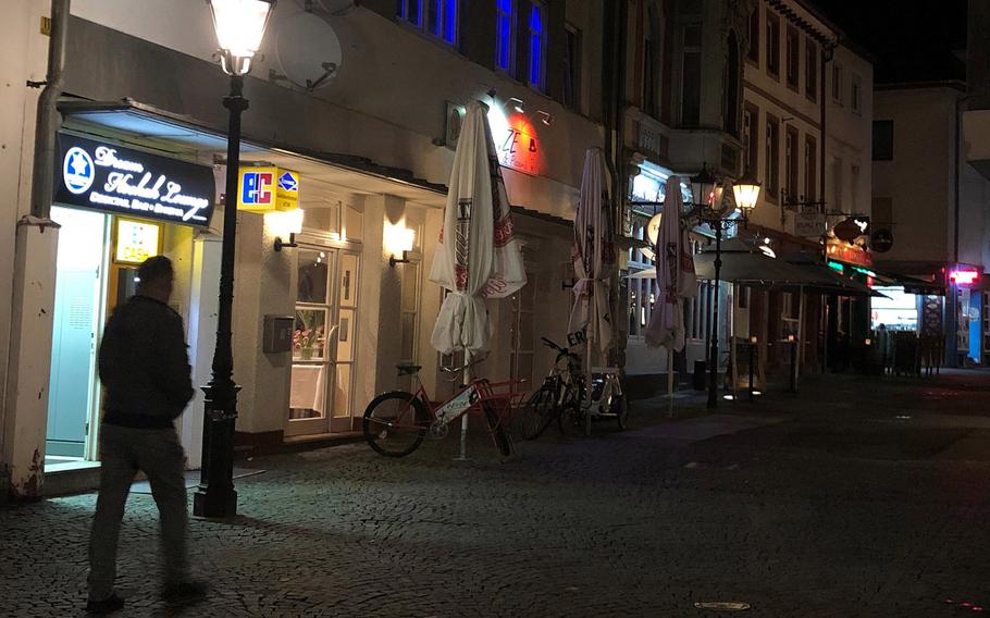 A person walks through the pedestrian zone in Kaiserslautern, Germany. The city, which is home to a large U.S. military community, will be under a 9 p.m. to 5 a.m. curfew starting Friday, April 16, 2021, following a sharp rise in new coronavirus infections.