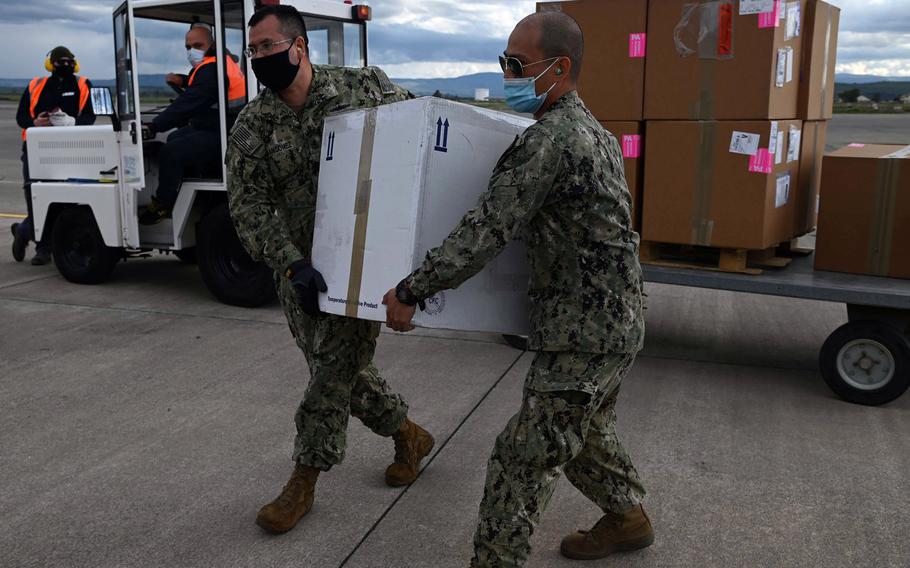 Chief Petty Officer Wilder Fermangomez, left, and Petty Officer1st Class Rolando Sol, Defense Logistics Agency Distribution Sigonella, carry COVID-19 vaccines headed for the aircraft carrier USS Dwight D. Eisenhower from Naval Air Station Sigonella, Italy, in March 2021. More doses should arrive soon following a slow start to the Europe vaccination campaign, U.S. European Command's Gen. Tod Wolters told Congress on April 15, 2021.  

