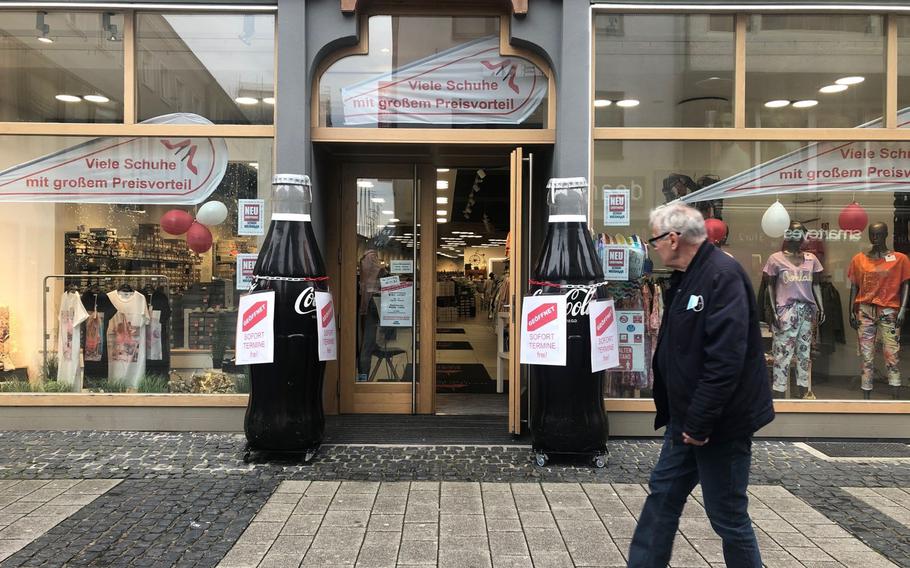 A man passes a shoe store in the pedestrian zone in Kaiserslautern that offers immediate appointments for shoppers. The Kaiserslautern district tightened coronavirus restrictions on April 19, 2021, as new infections surged.

