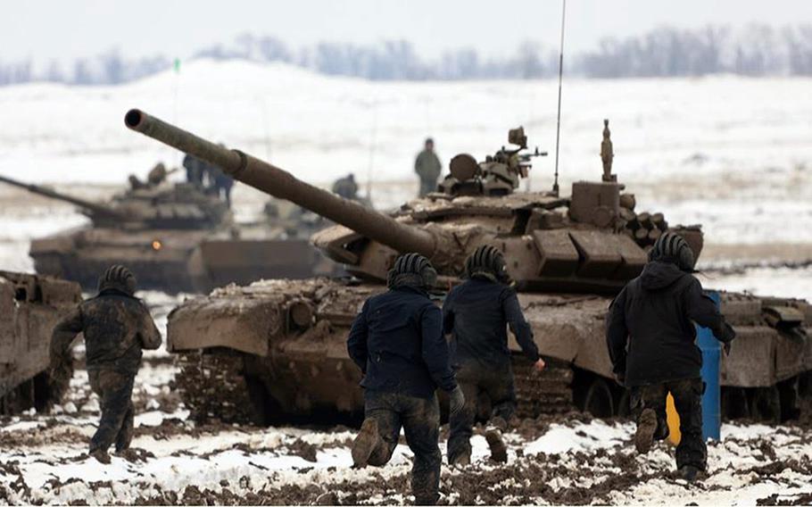 Armor troops of the Russian Southern Military District sprint to their tanks during training in March 2021. The Pentagon says Russia's military presence around Ukraine is now larger than the force used during Moscow's 2014 invasion of that country.

