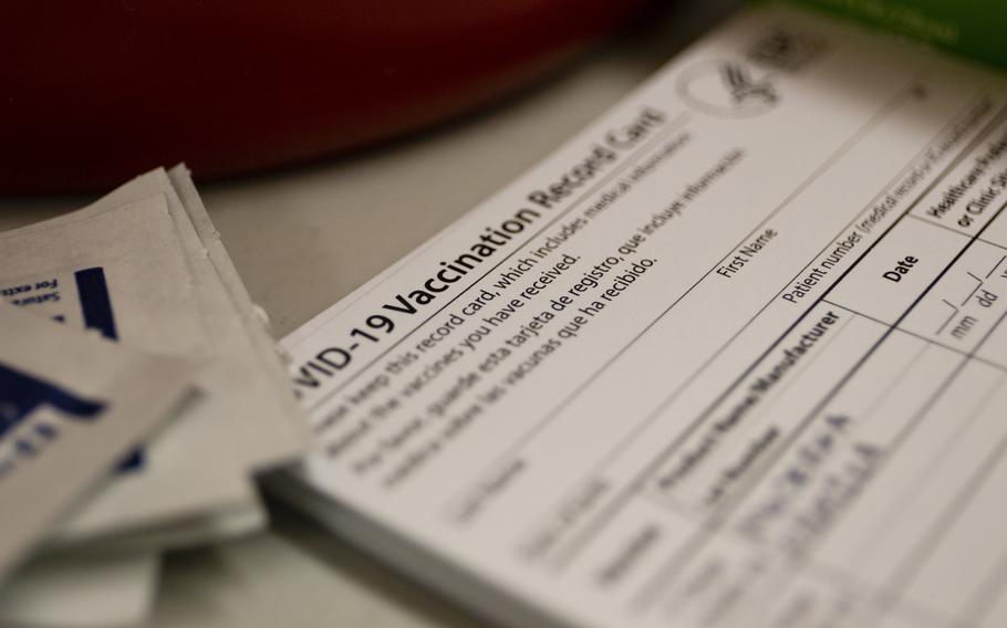 COVID-19 vaccination cards sit on the desk of a health care worker at Marine Corps Base Hawaii, Feb. 18, 2021. Fully vaccinated people who have no symptoms of COVID and show a vaccination card don't need to have a coronavirus test before going to a restaurant or other business in Rheinland-Pfalz, Germany, officials say. 
