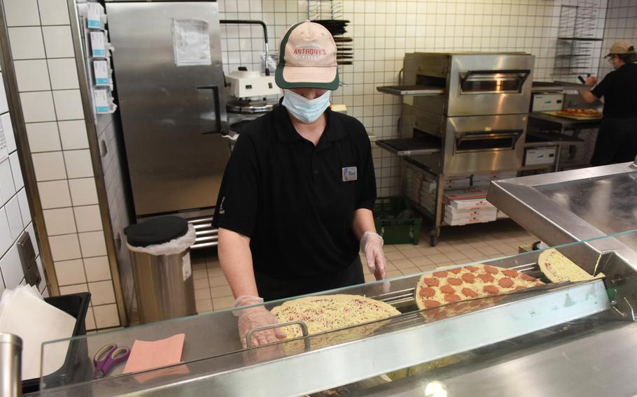 Tina Klassen, a worker at Anthony's Pizza at Ramstein Air Base, Germany, prepares pizzas Wednesday, April 21, 2021.  The Exchange-brand pizzeria, which has dished out pizza for more than 30 years, is closing its last Europe location May 1.

