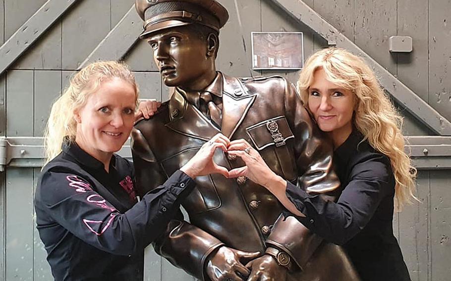 Meike Berger, left, and Angela Storm with the life-size bronze statue of Elvis Presley, in October 2020, at the Rincker foundry in Sinn, Germany. They initiated a GoFundMe page to raise money to produce the statue, modeled after a photo of Presley, that will be placed on a bridge in Bad Nauheim, Germany, where the King as a soldier in the late 1950s.


