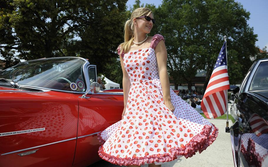 A person wearing a 1950s-style dress poses in front of a classic American car during the Elvis festival in Bad Nauheim, Germany, in 2010. The city plans to host the festival again this year, when a life-size bronze statue of Presley is to be installed on a city bridge.

