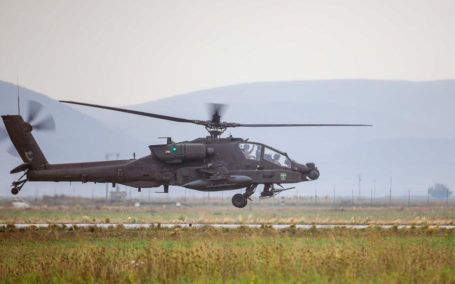 An AH-64E Apache helicopter assigned to 1st Battalion, 101st Combat Aviation Brigade, flies into Stefanovikeio Airfield, Greece, Nov. 10, 2020. About 40 members of the battalion went on an official trip in September to Gdansk, Poland, where several leaders went to an off-limits strip club and a major who was likely drugged went missing until the next day, an Army investigation found.

