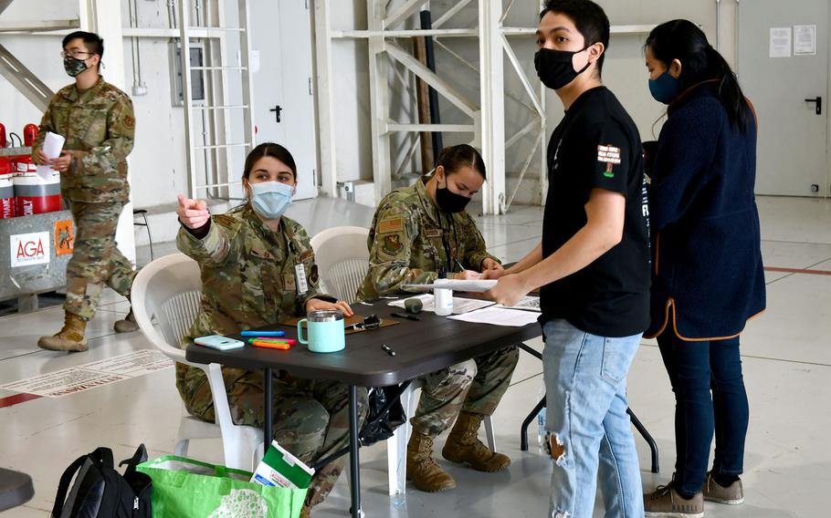 An airman assigned to the 31st Medical Group directs a person during a COVID-19 vaccination line at Aviano Air Base, Italy, April 23, 2021. The medical group administers Moderna vaccinations to U.S. personnel.

