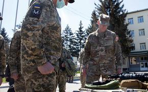 Maj. Gen. David Tabor, commander of  U.S. Special Operations Command Europe, right, receives a weapons briefing at the 142nd Training Center near Kyiv, Ukraine, April 28, 2021. Service members who train at the facility are familiarized with all weapons systems that they may encounter in the region.

