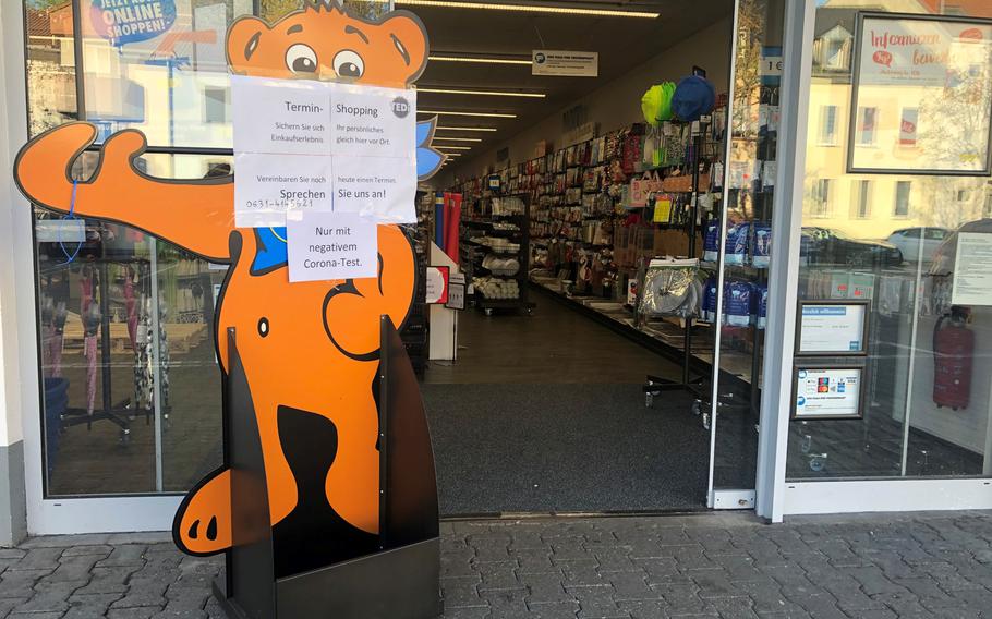 A sign outside a shop in Kaiserslautern, Germany, on April 24, 2021, says customers are welcome as long as they have a negative coronavirus test and appointment.

