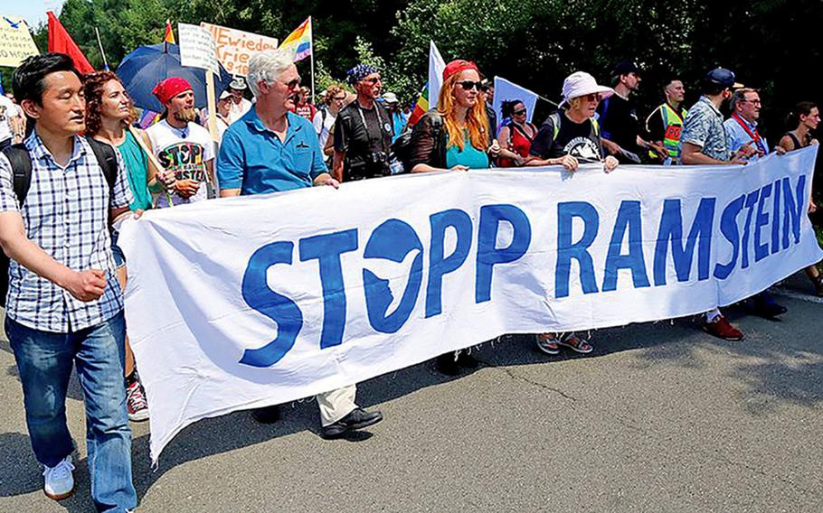 Protesters march outside Ramstein Air Base, Germany, in June 2018. Demonstrators will ride bicycles around the base on April 30 and May 1, 2021, to protest its use as a relay station for drone strikes, and call for it to be shut down.
