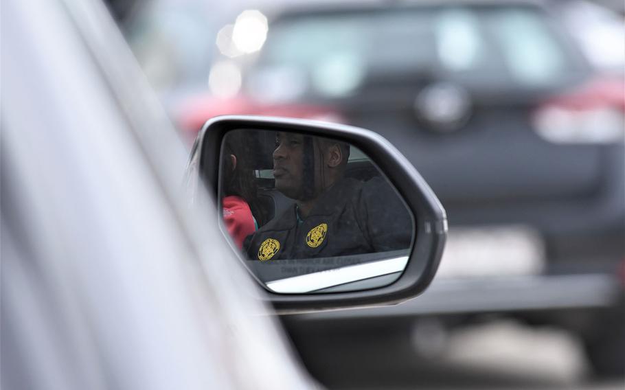 A graduate sits in his car on the airfield on Clay Kaserne in Wiesbaden, Germany, waiting to be called up to the stage. The University of Maryland Global Campus Europe held a drive-in movie style commencement ceremony for the class of 2021 on Saturday, May 1, 2021.