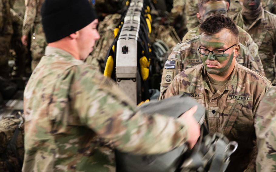 A 3rd Brigade Combat Team, 82nd Airborne Division, paratrooper receives a T-11 parachute onboard a C-17 Globemaster III aircraft bound for Estonia during Swift Response 21, May 7, 2021. 