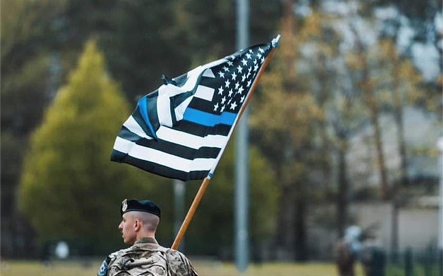 A screenshot of a photo on Ramstein Air Base’s Facebook page Tuesday shows a security forces airman carrying a black-and-white American flag with a blue line through it. The photo was posted to show support for the airmen during National Police Week. It was taken down after the base said it violated a Pentagon policy on what types of flags may be displayed on U.S. military installations.

