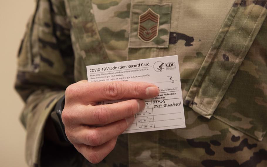 A U.S. airman holds a COVID-19 vaccination card during the first phase of immunizations on Jan. 8, 2021, at Incirlik Air Base, Turkey. Travelers to Germany from Turkey only have to quarantine for five days as of May 13, 2021, and travelers from the U.S. don't need to quarantine at all if they are fully inoculated or can show they have recovered from the virus.
