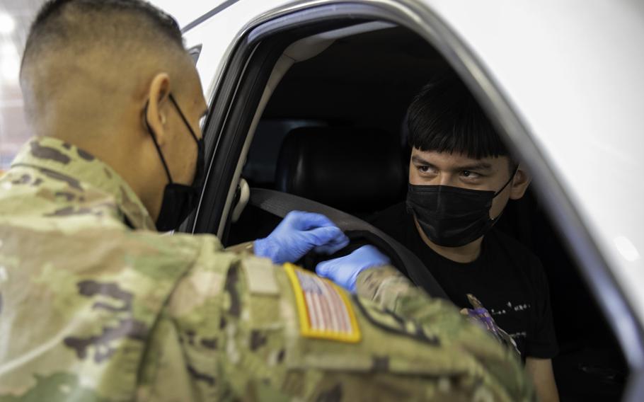 Sgt. Gilberto Armento, with the Arizona Army National Guard, assists with immunizations at a COVID-19 vaccination site in Mesa, Ariz., May 13, 2021. The unit began vaccinating children between the ages of 12 and 17 after the Centers for Disease Control and Prevention gave the green light to use the Pfizer vaccine for that age group.  Several U.S. bases in Europe are planning to offer the vaccine to kids in that age group starting next week.