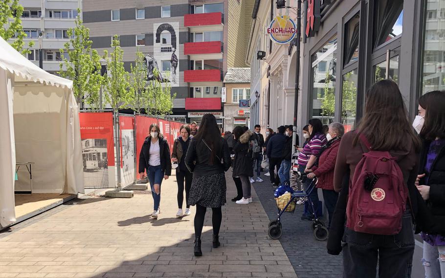 People wait in line for a free coronavirus antigen test in Schillerplatz, downtown Kaiserslautern, Germany, on May 17, 2021. U.S. service members, contractors and their families, who previously paid for the tests, can access them free-of-charge once a week, German health officials said.
