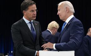Netherland's Prime Minister Mark Rutte, left, speaks with U.S. President Joe Biden during a round table meeting at a NATO summit in Madrid, Spain, June 29, 2022. Biden is set to host Dutch Prime Minister Mark Rutte for talks. The U.S. administration is looking to persuade the Netherlands to further limit China's access to advanced semiconductors with export restrictions. 