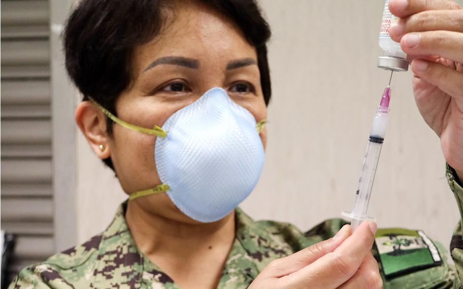 Lt. Cmdr. Kathleen Bautista, a nurse at U.S. Naval Hospital Naples, prepares a syringe with the Moderna COVID-19 vaccine in Naples, Italy, in February 2021. Naples has vaccinated at higher rates than much of the U.S. military community in Europe, which has suffered from vaccine shortages.

