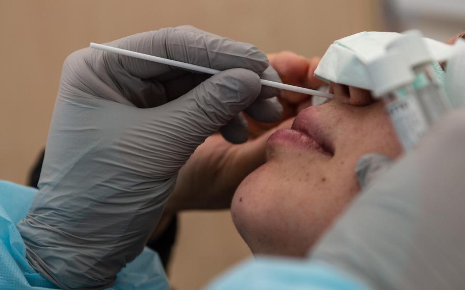 Spc. Thomas Ashworth, medical technician, uses a nasal swab to test a patient for coronavirus at the COVID-19 clinic at Landstuhl Regional Medical Center, Germany, March 20, 2020. 