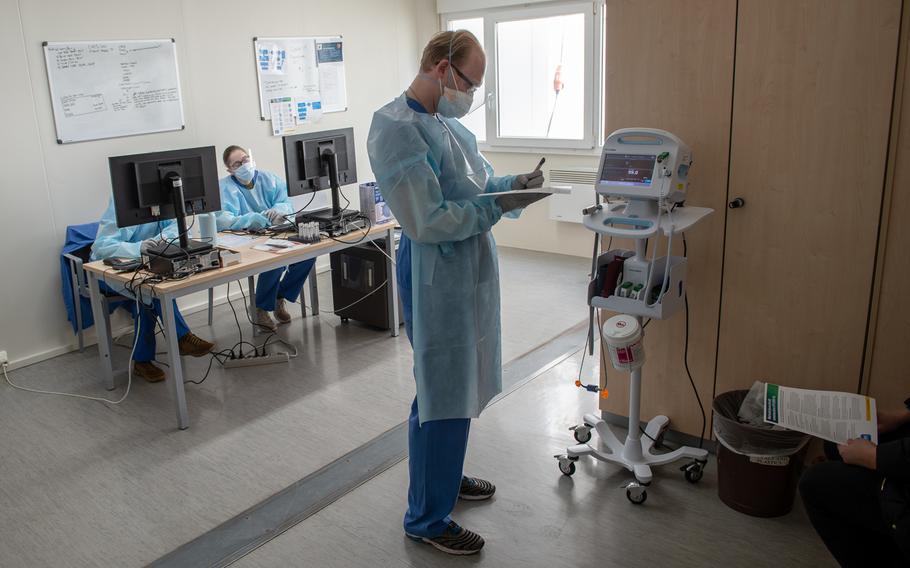 Spc. Thomas Ashworth, medical technician, screens a patient for coronavirus at the COVID-19 clinic at Landstuhl Regional Medical Center, Germany, March 20, 2020. 