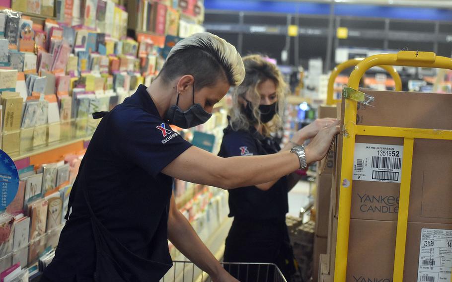 Exchange employees Tiziana Mantovani, left, and Agnese Ciwis stock the Aviano store Tuesday, May 19, 2020, after it made all of its products available for purchase. An Italian decree that eased coronavirus restrictions starting Monday expanded the variety of products that stores can sell.

