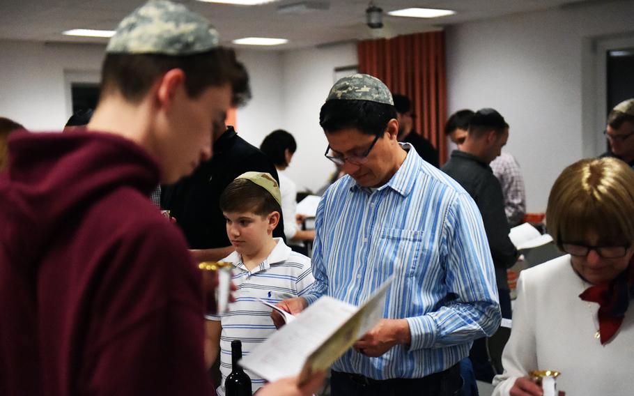Soldiers and families read about the Exodus during a Passover celebration at Grafenwoehr, Germany, Friday, April 19, 2017. 
